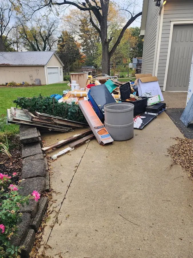 Dumpster being loaded with debris for Estate Cleanout Dumpster Rental in Manasquan